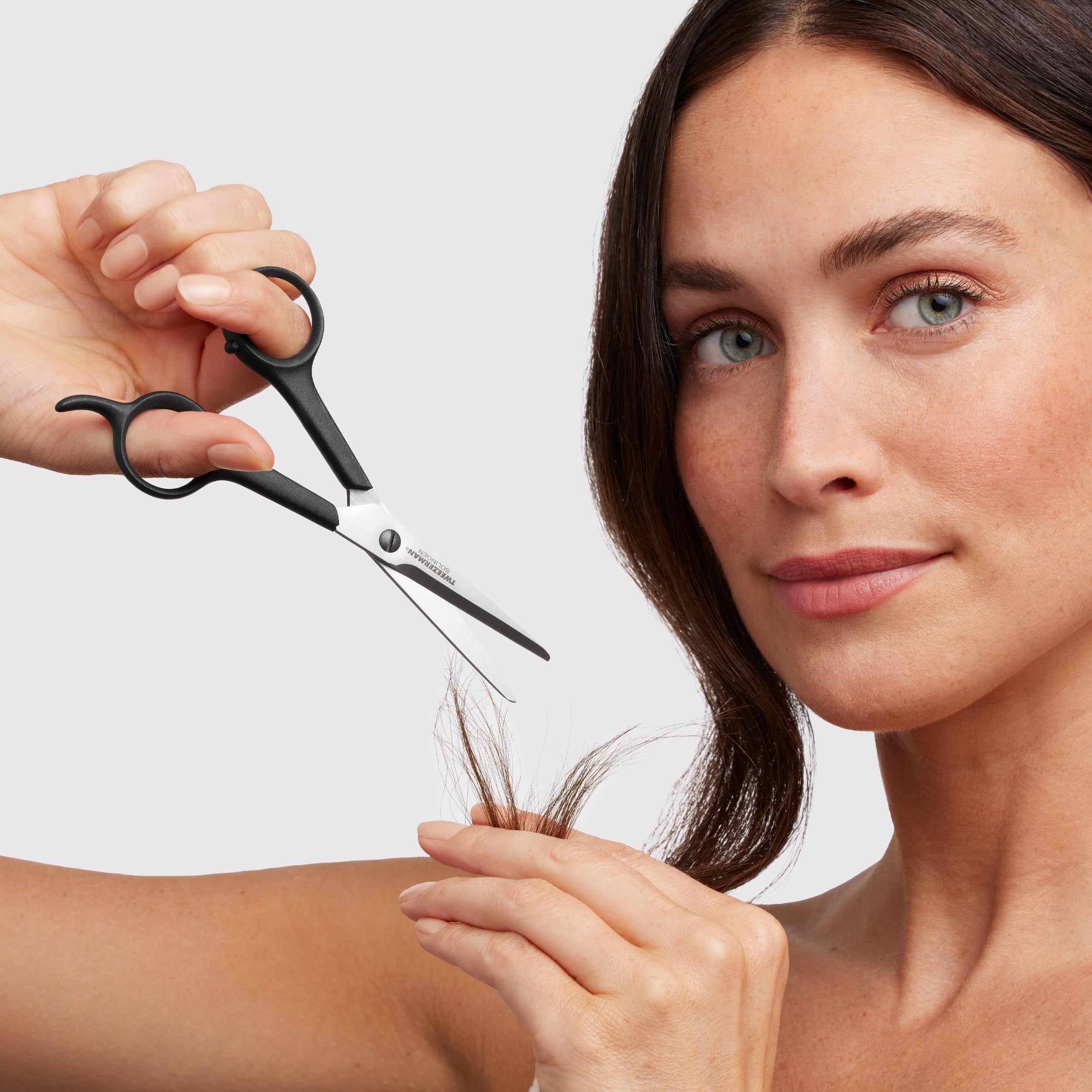 Tweezerman hairdressing scissors showing the large ergonomic black plastic finger loops.