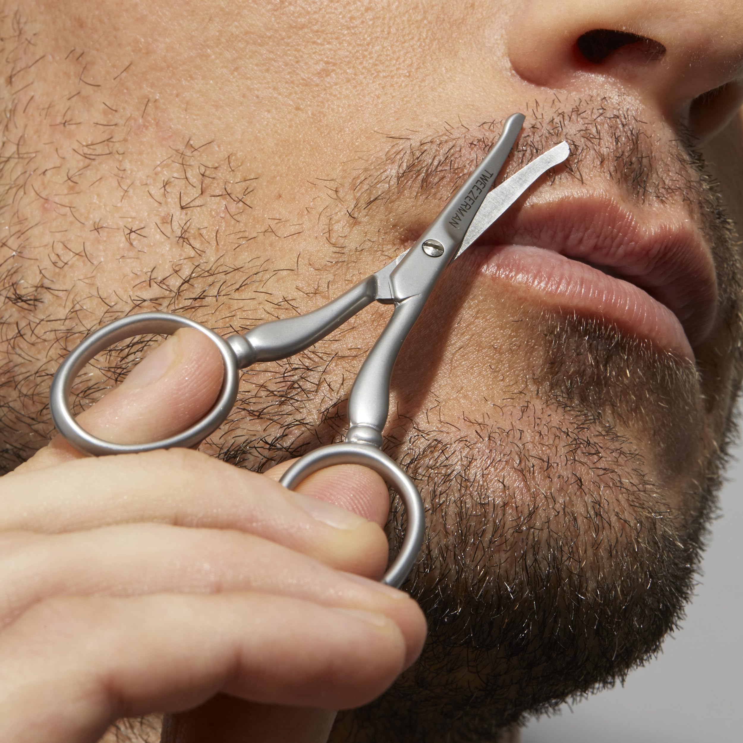 Ergonomic stainless steel scissors by Tweezerman for safe nose and ear hair trimming