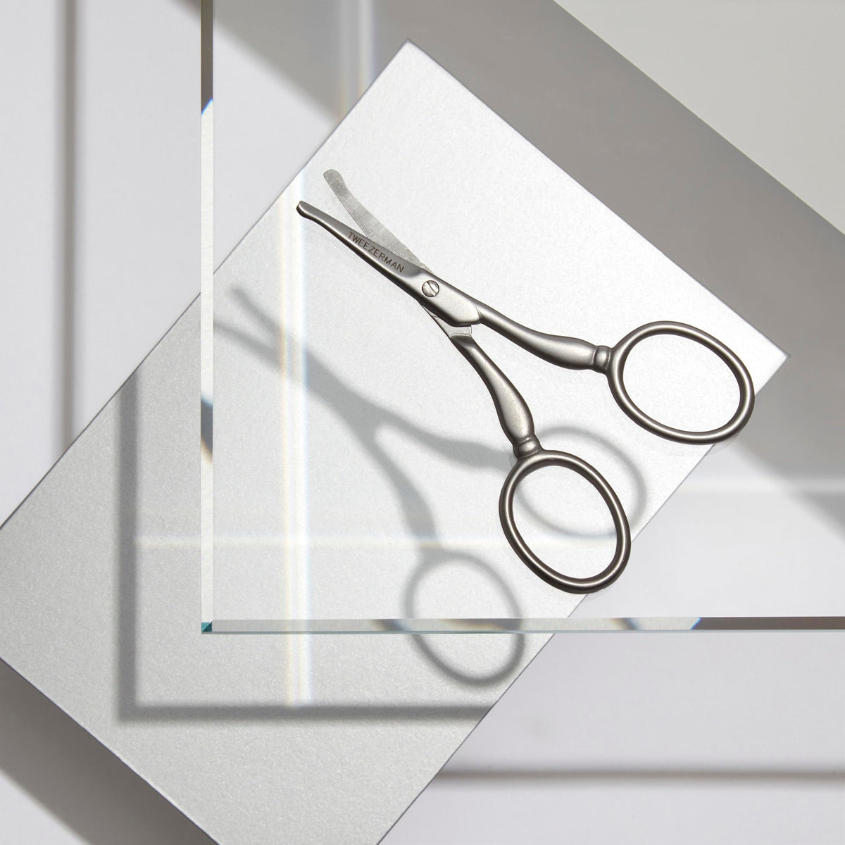 Tweezerman curved precision blade scissors highlighting the durable stainless steel finish