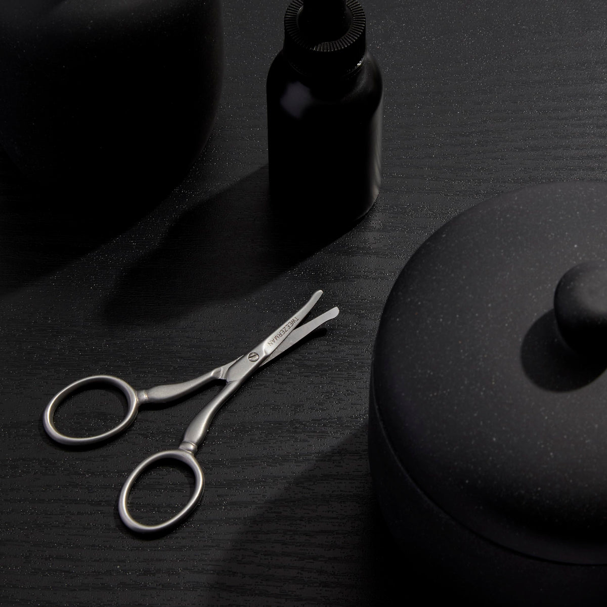 Professional grade Tweezerman facial hair scissors displaying the safe rounded tip design