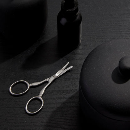 Professional grade Tweezerman facial hair scissors displaying the safe rounded tip design