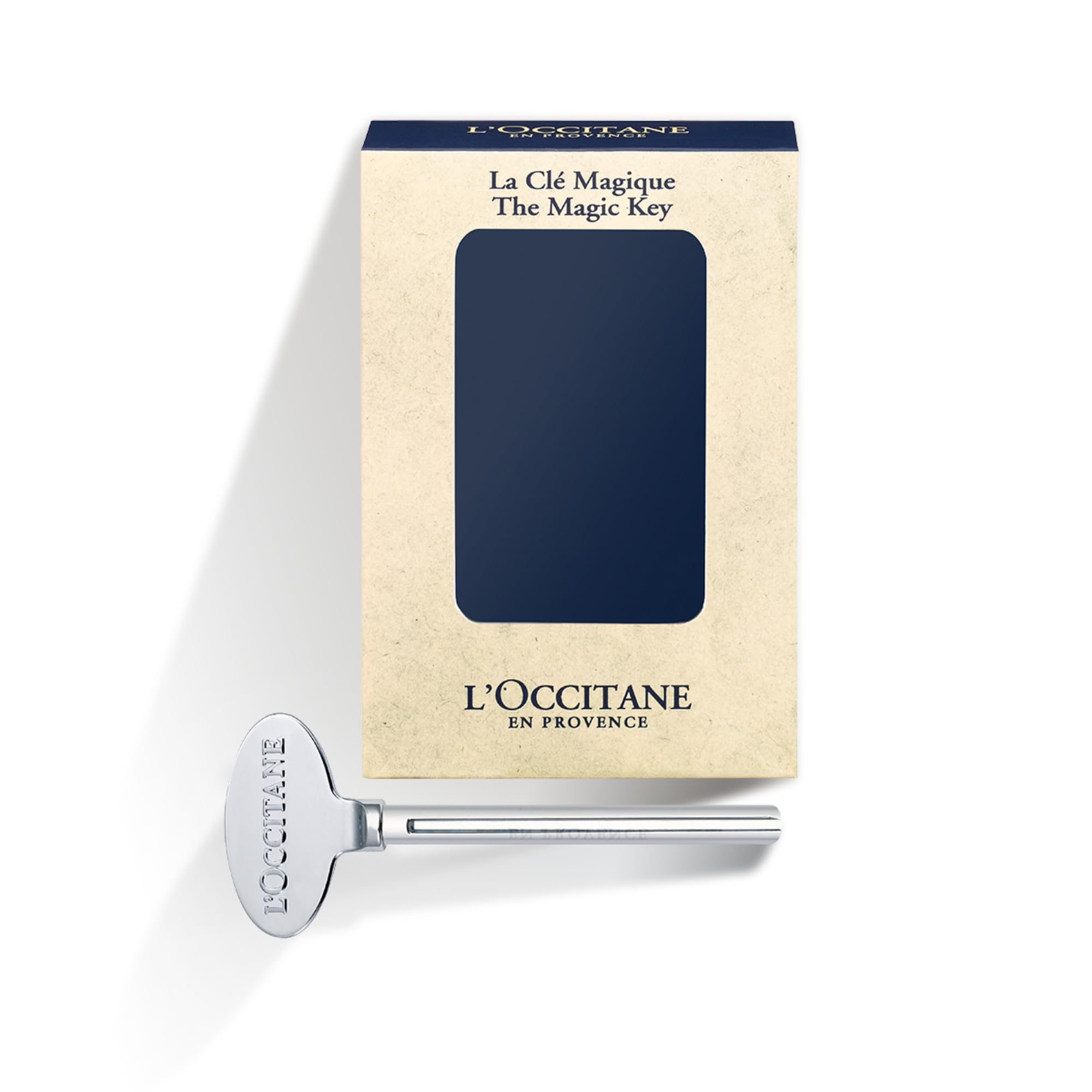Close up of L'Occitane Magic Key attached to a hand cream tube.