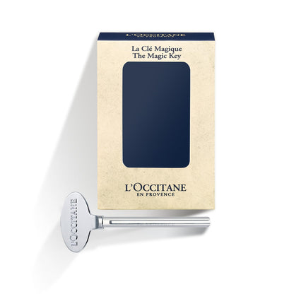 Close up of L'Occitane Magic Key attached to a hand cream tube.