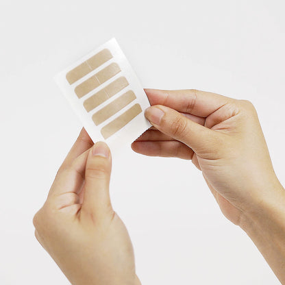 Clear hair replacement adhesive tabs laid flat demonstrating the regular four centimeter size specifications