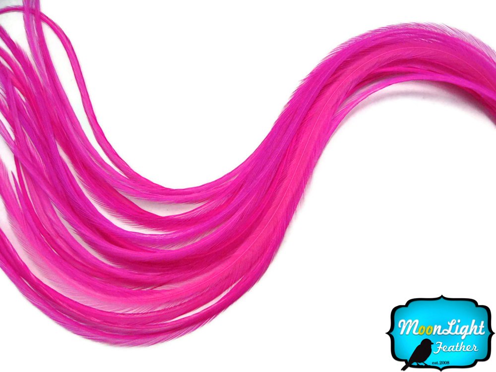 Close up of thin long hot pink hair feathers