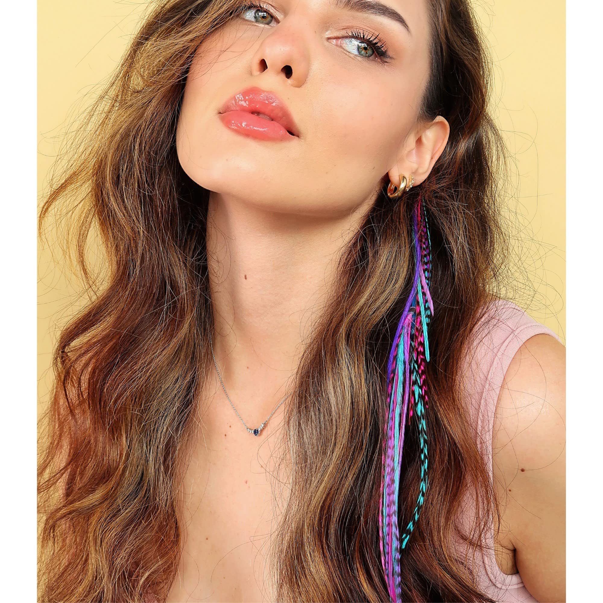 Model wearing pink blue and purple feather hair accessories