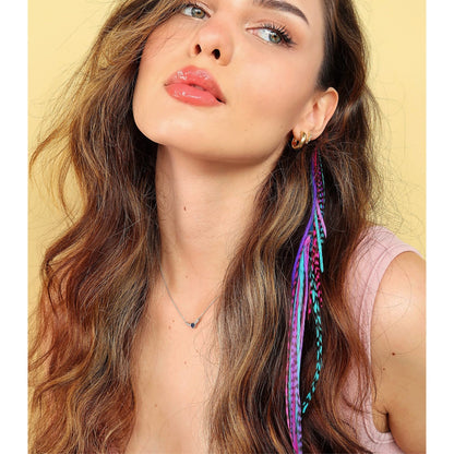 Model wearing pink blue and purple feather hair accessories