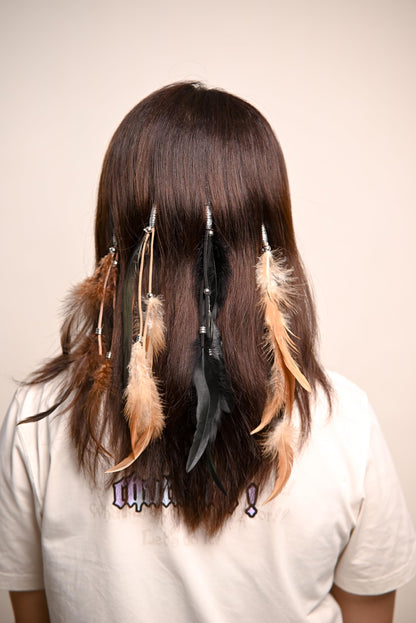 Model wearing boho feather hair extensions