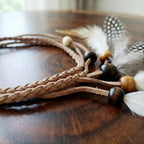 Close up of clip-in feather hair extension for women