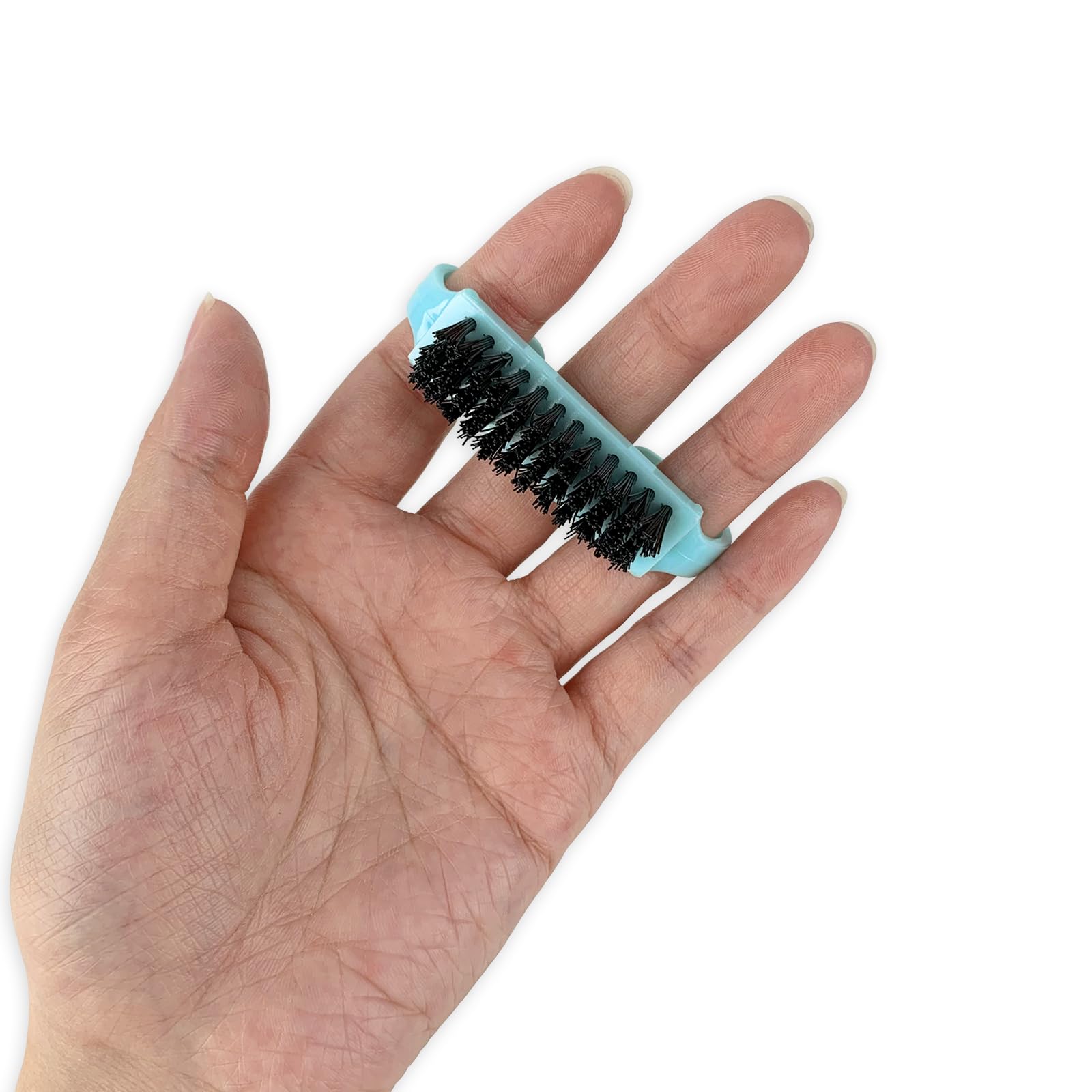 Compact travel size nail brush held in hand