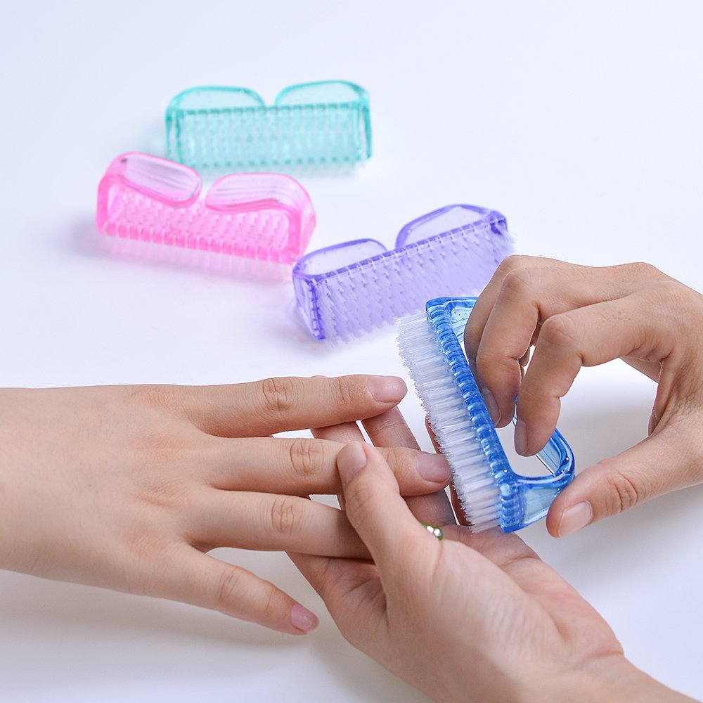 Hupos hand scrubbing brush hanging on a bathroom hook for storage.