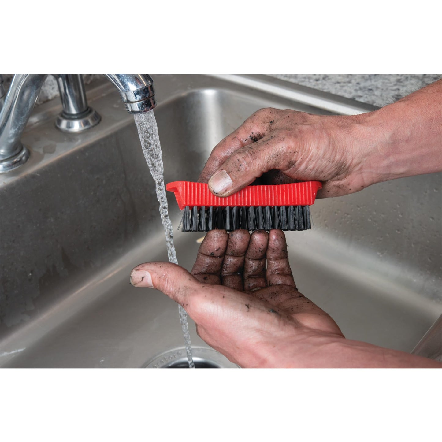Performance Tool combo fingernail brush stored magnetically on the side of a steel garage toolbox.