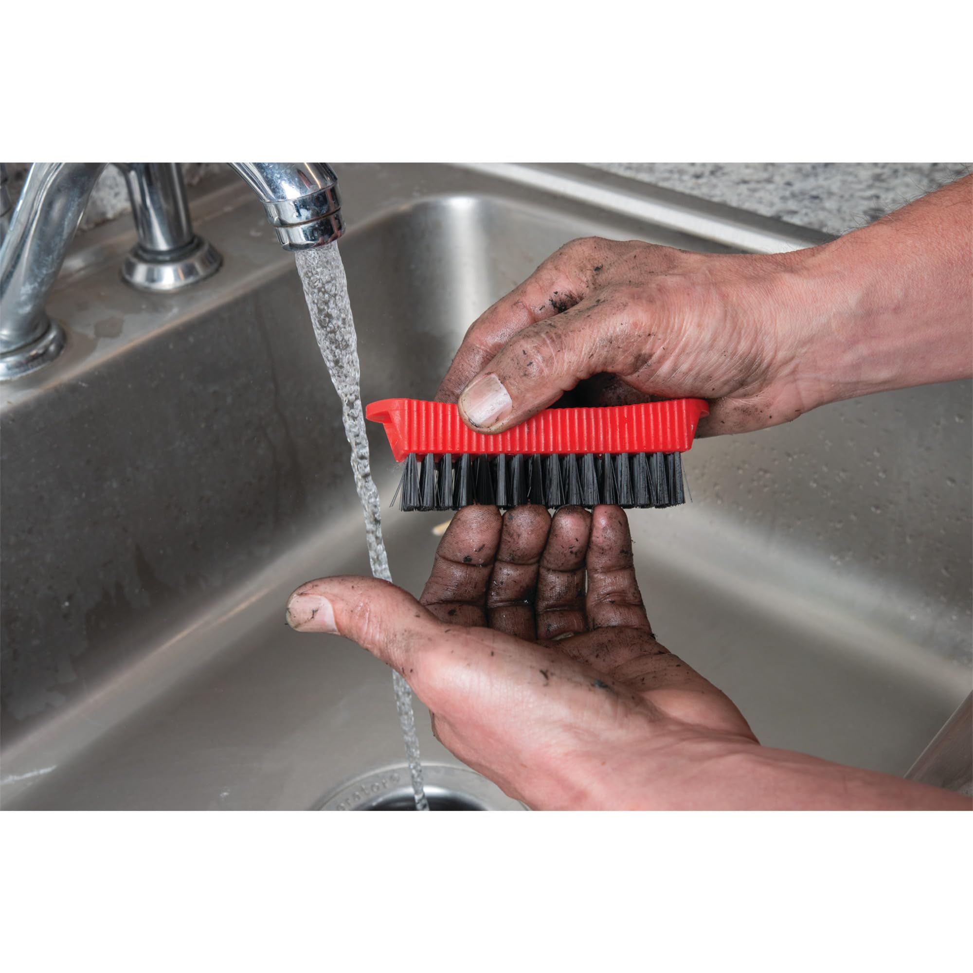 Performance Tool combo fingernail brush stored magnetically on the side of a steel garage toolbox.