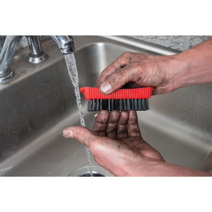 Performance Tool combo fingernail brush stored magnetically on the side of a steel garage toolbox.