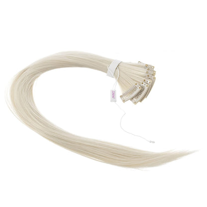 Close up view of the secure pressure sensitive clip mechanism on the platinum blonde synthetic hairpiece.