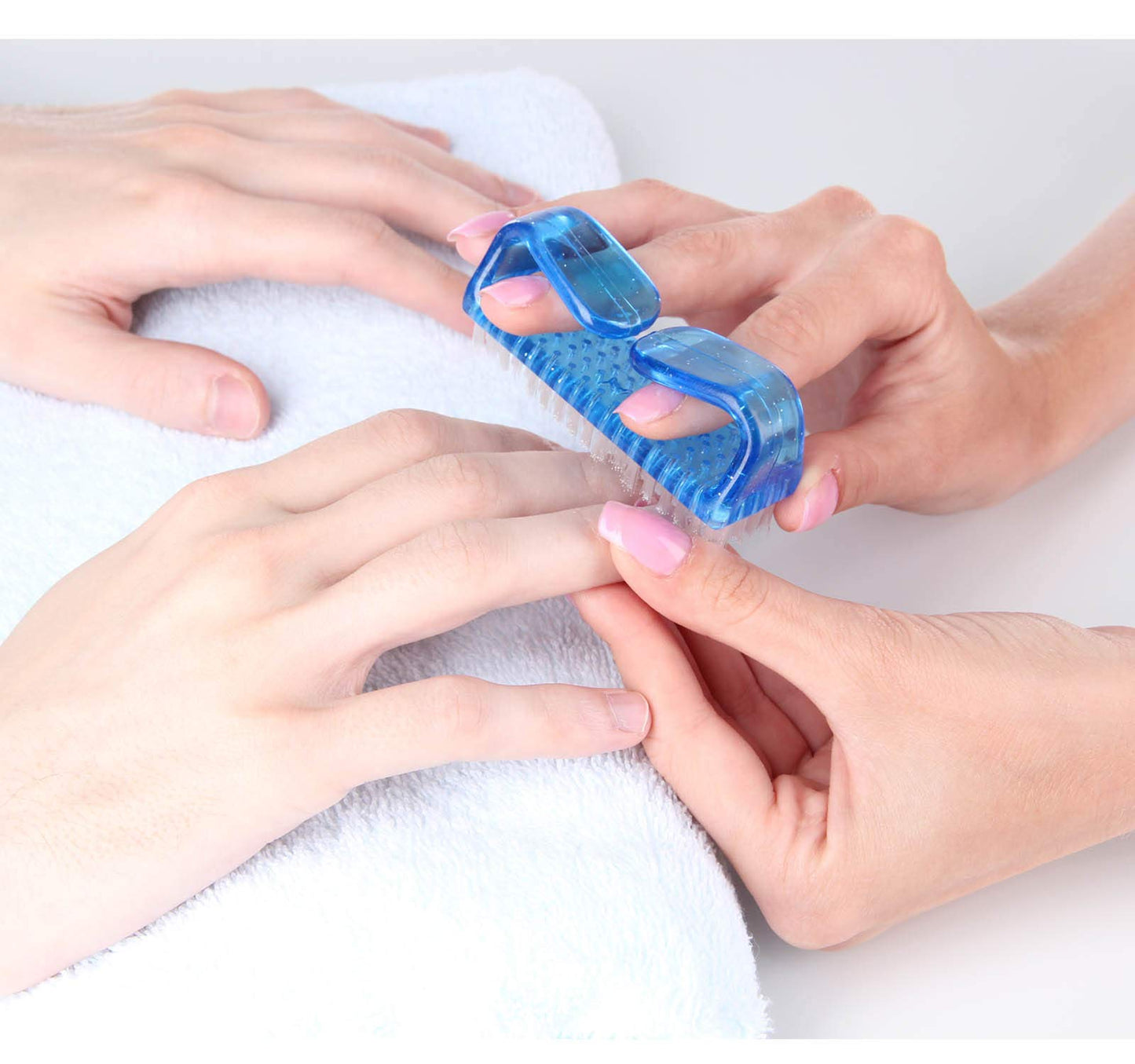 Four colorful plastic nail cleaning brushes arranged neatly to demonstrate color coding utility