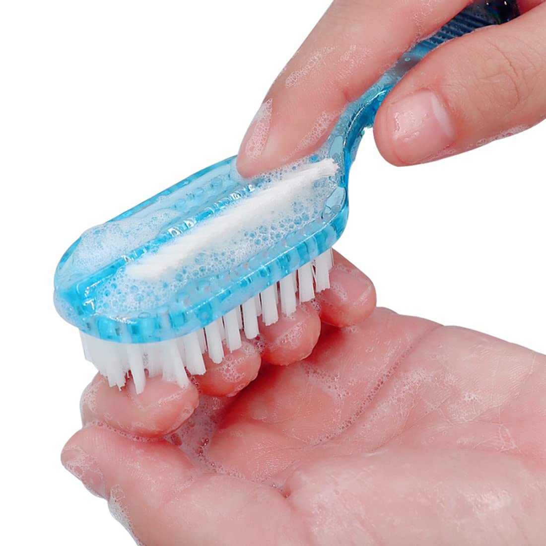 Angled side of fingernail brush removing dirt from under toenails and cuticles