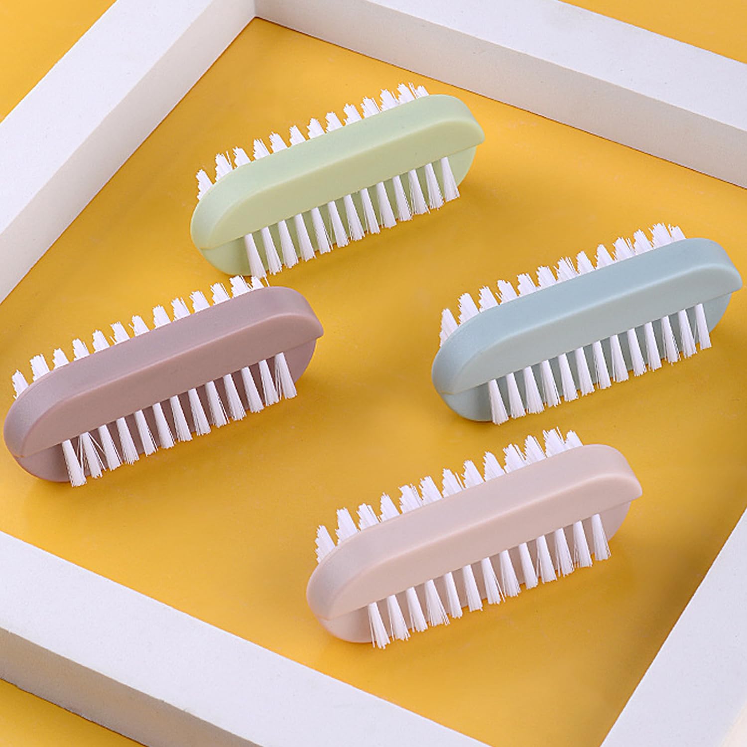 Close up of the dual sided nail cleaning brush illustrating soft long bristles and stiff short bristles