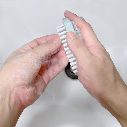 Nail brush for cleaning fingernails being held securely to demonstrate the compact non slip grip