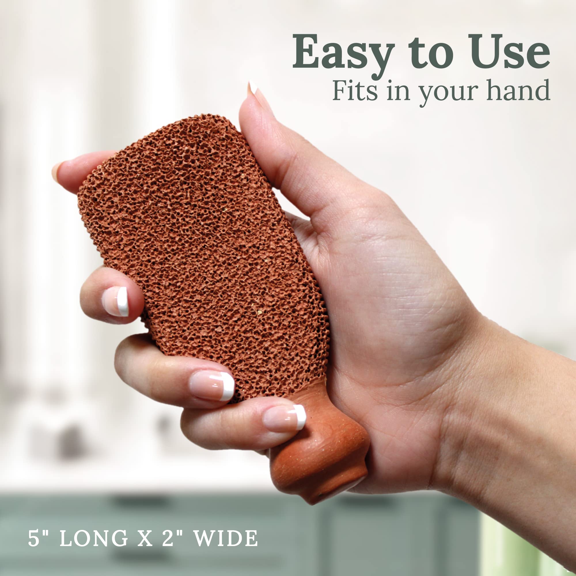 Hand holding Gilden Tree ergonomic foot scrubber in shower
