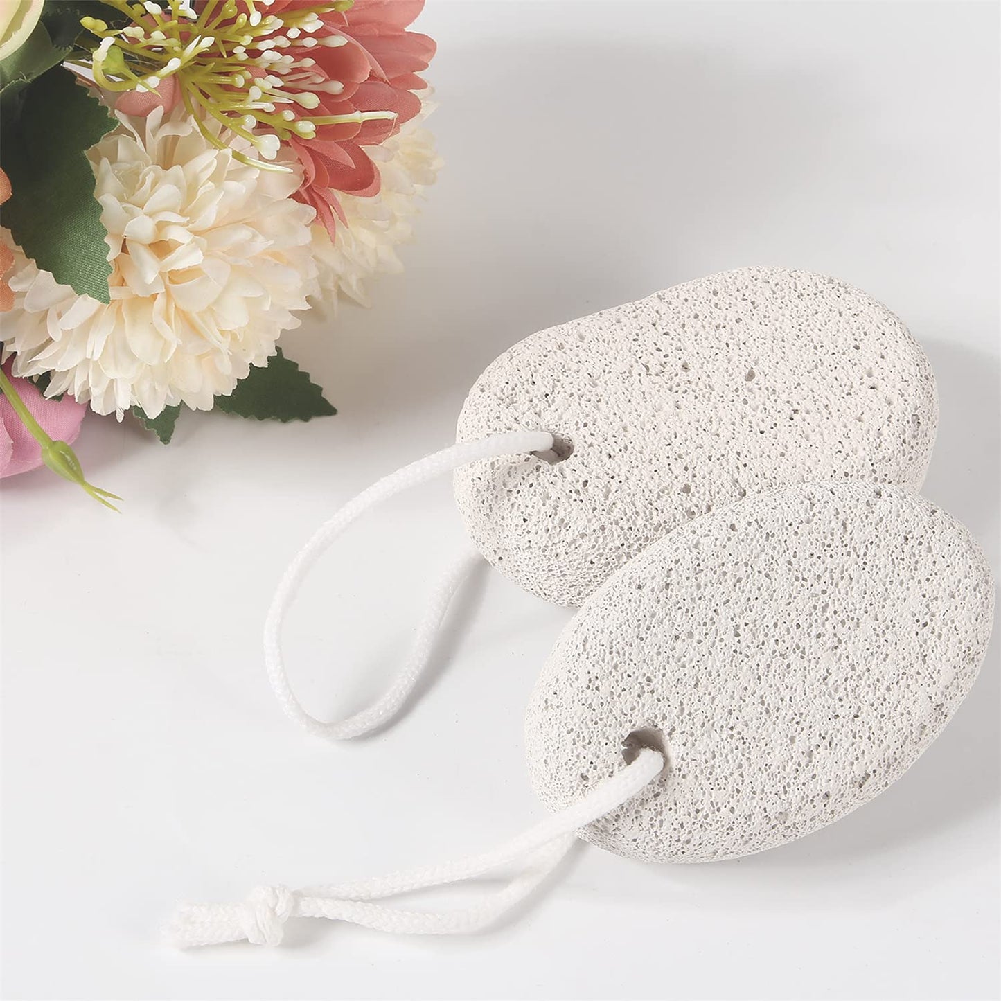 Asqraqo pumice stone held in hand during foot exfoliation