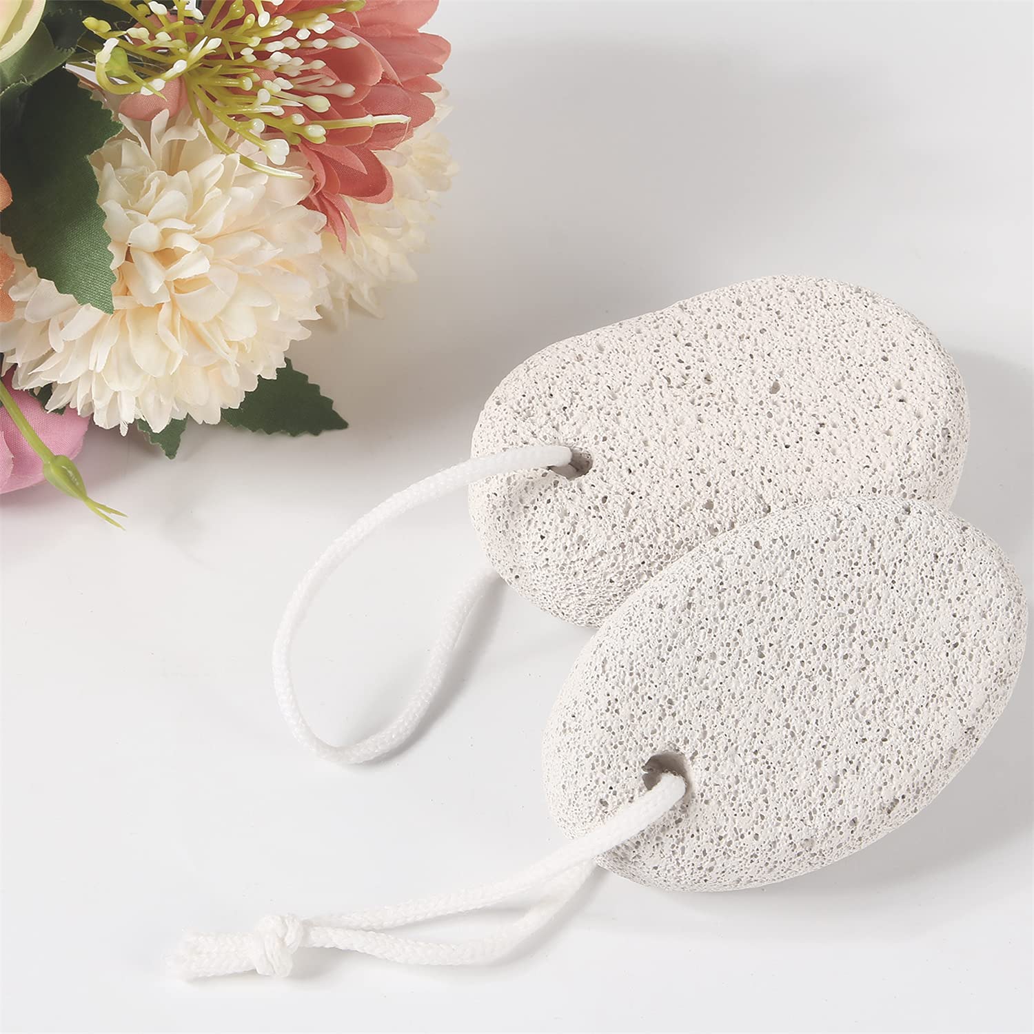 Asqraqo pumice stone held in hand during foot exfoliation