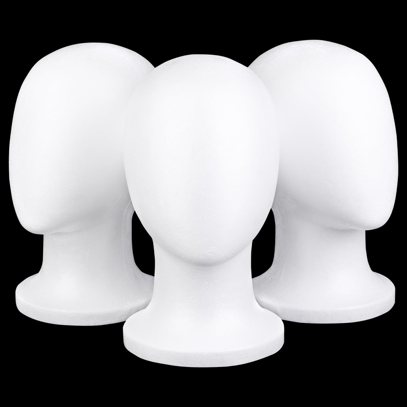 Three white foam mannequin heads arranged for hairpiece storage