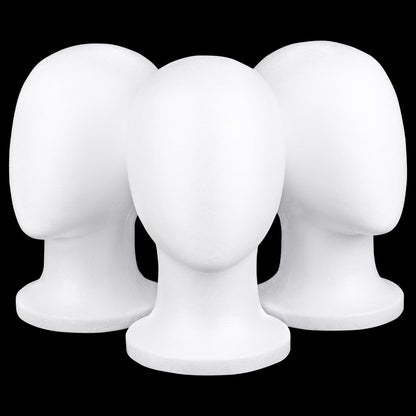 Three white foam mannequin heads arranged for hairpiece storage