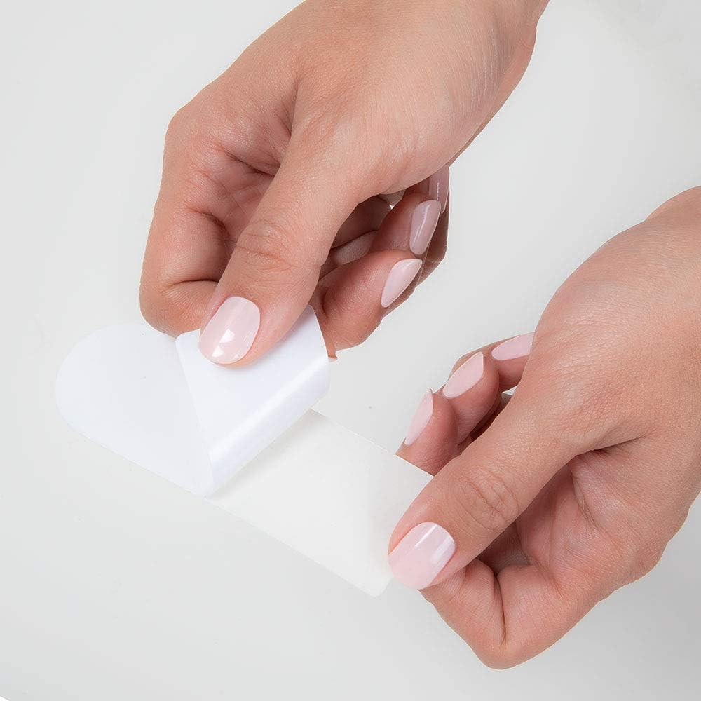 Demonstration of the EZ Strip peel off backing being removed from the water resistant pedicure pad.