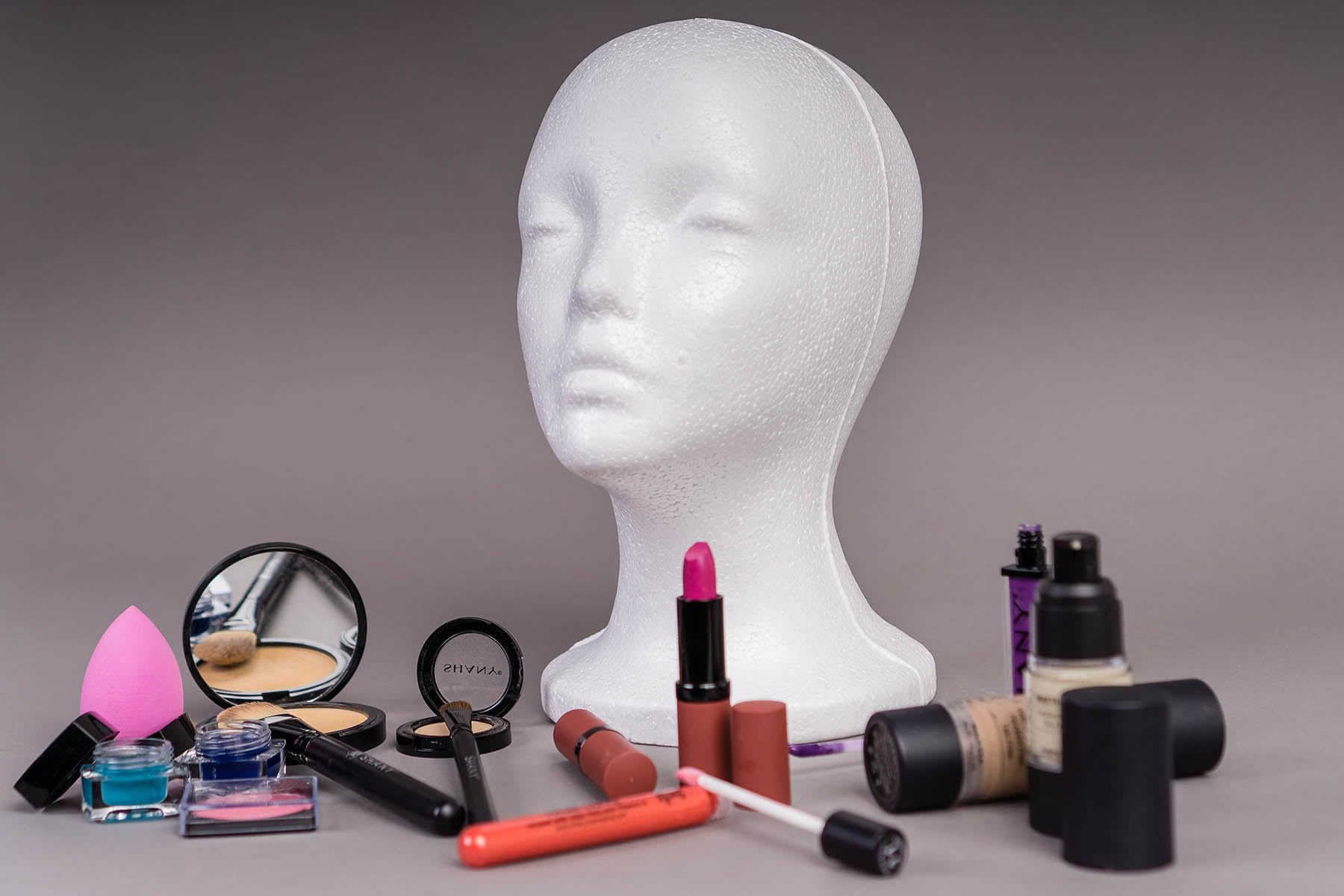 Professional cosmetology student using Shany foam mannequin head