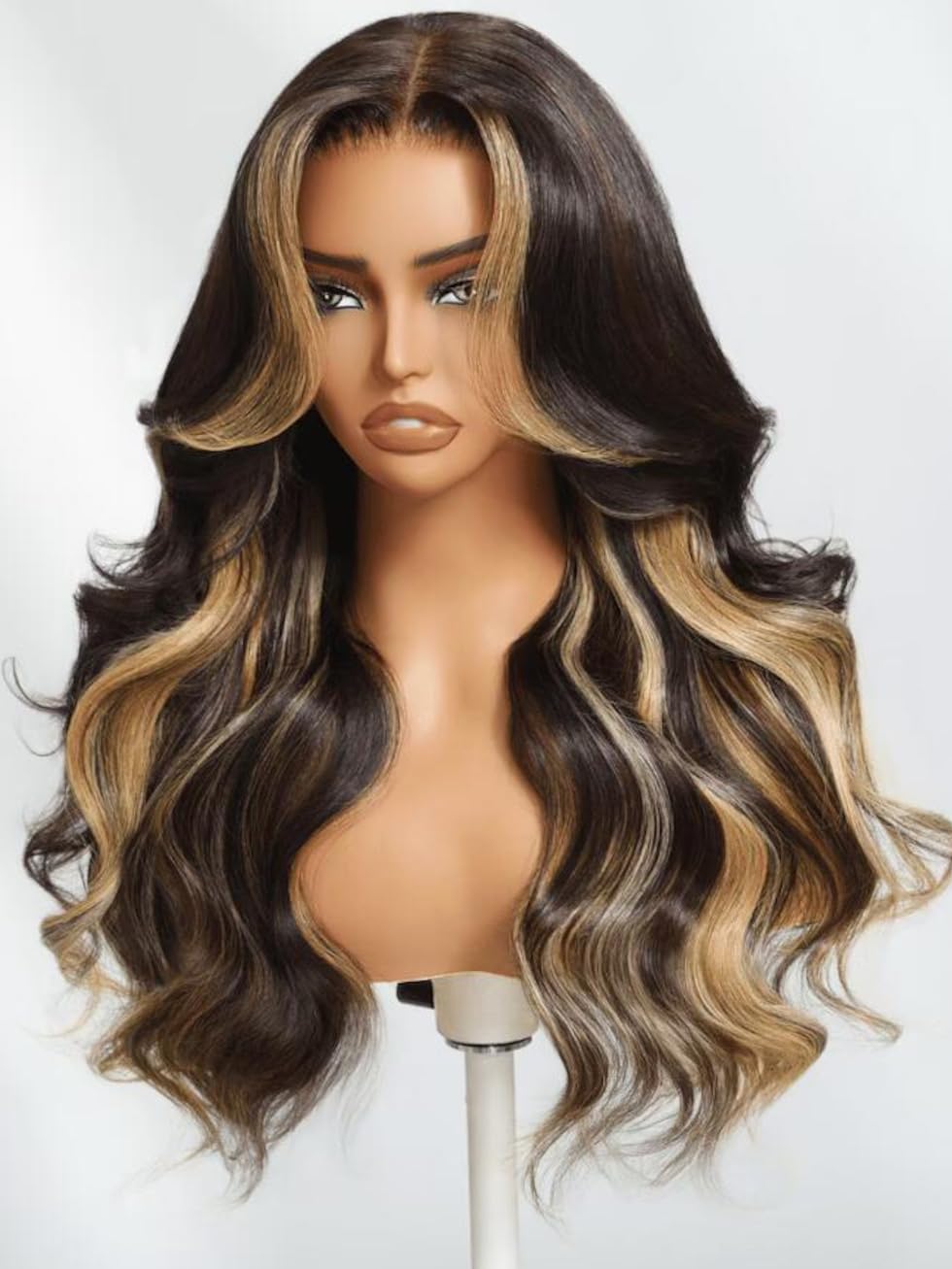 Model wearing UNICE butterscotch highlights brown loose wave wig showing natural hair movement and bounce