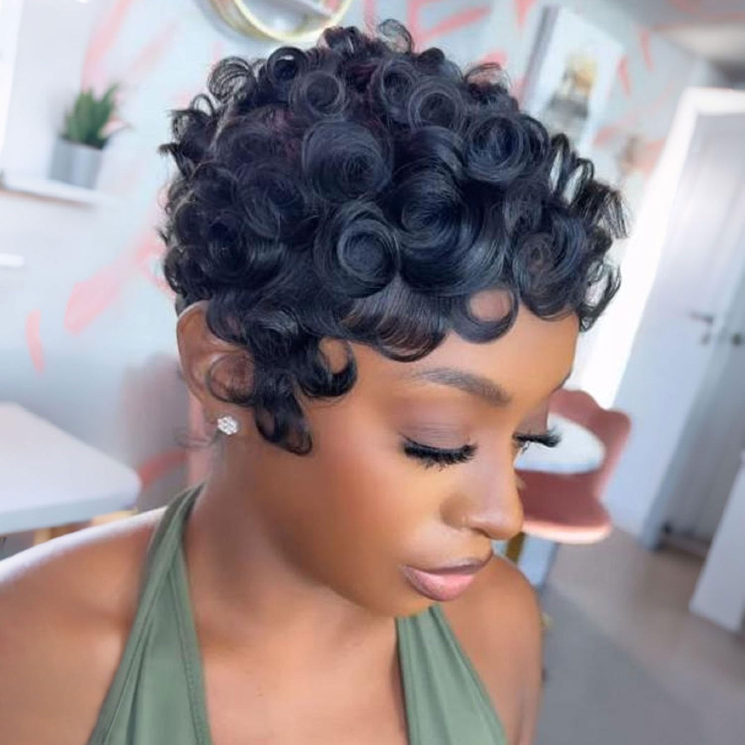 Side angle profile of the short layered Brazilian curly glueless hairpiece in natural black color.