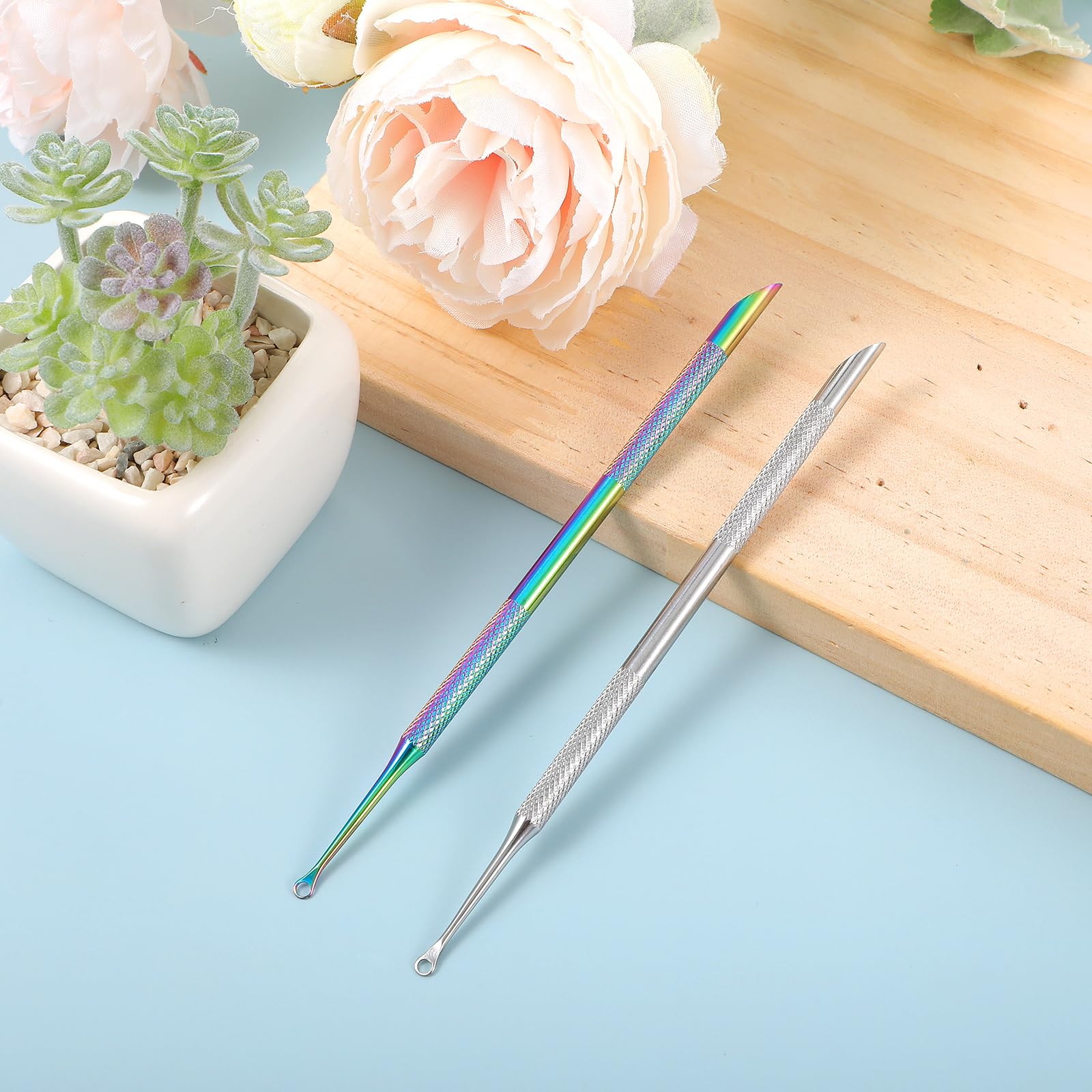 Two pieces of professional metal manicure tools showcasing the textured non slip handle detail