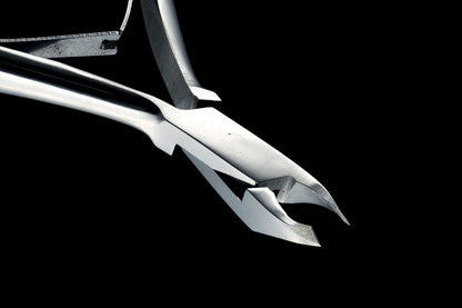 Handcrafted Japanese stainless steel cuticle nipper held in hand