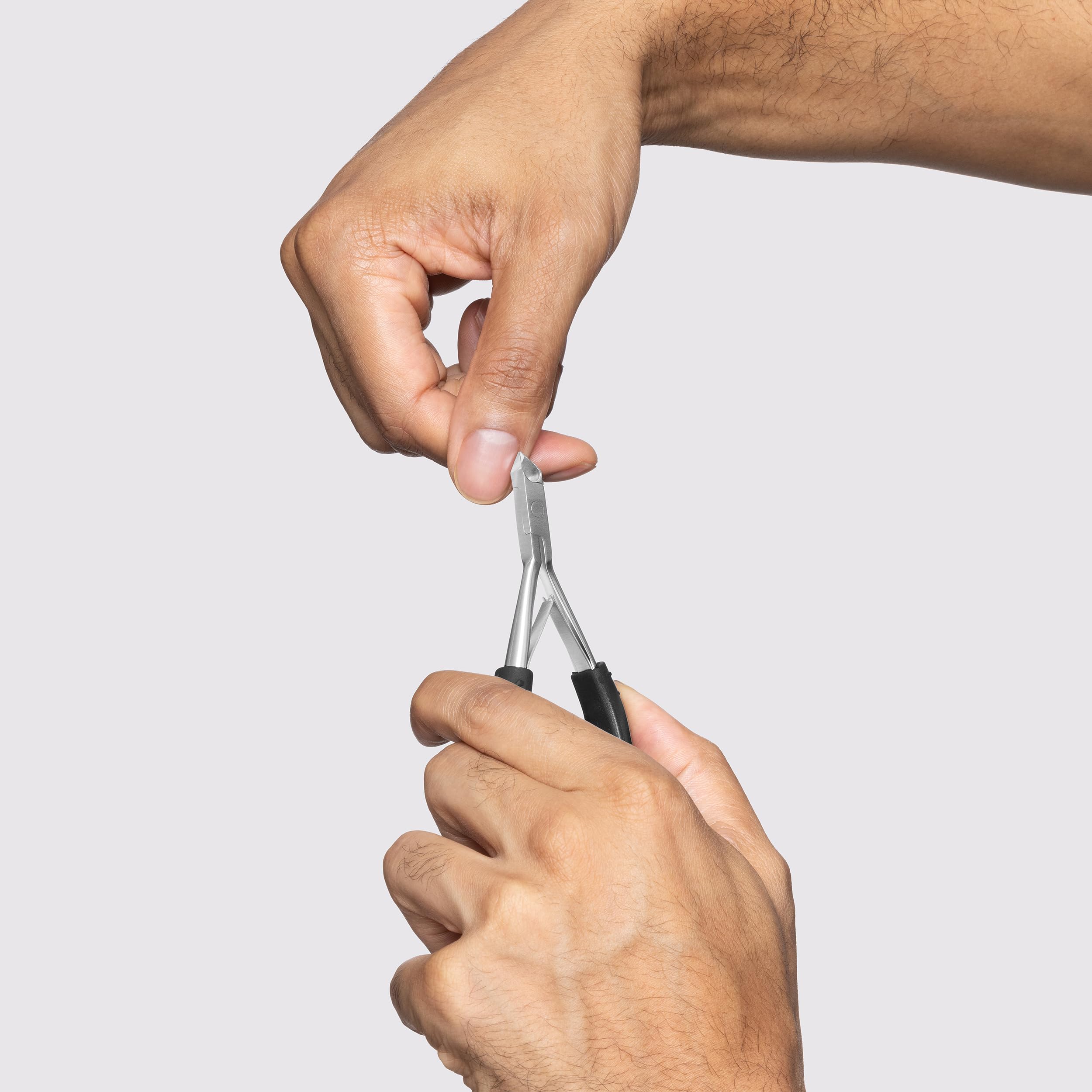 Ergonomic wide handle frame of Tweezerman cuticle nipper highlighting the double spring action mechanism