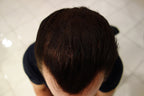 Side profile of final styled look using static charge hair building fibers