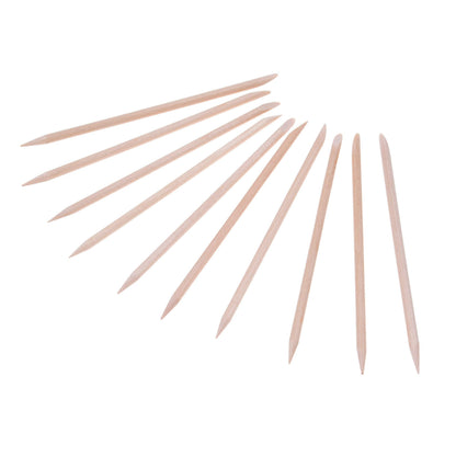 Orange wood nail sticks for manicure and pedicure grooming
