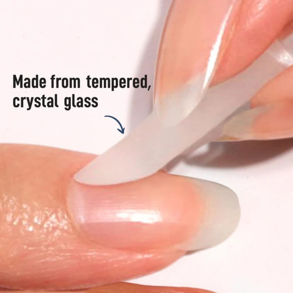 Hand using glass cuticle pusher for manicure
