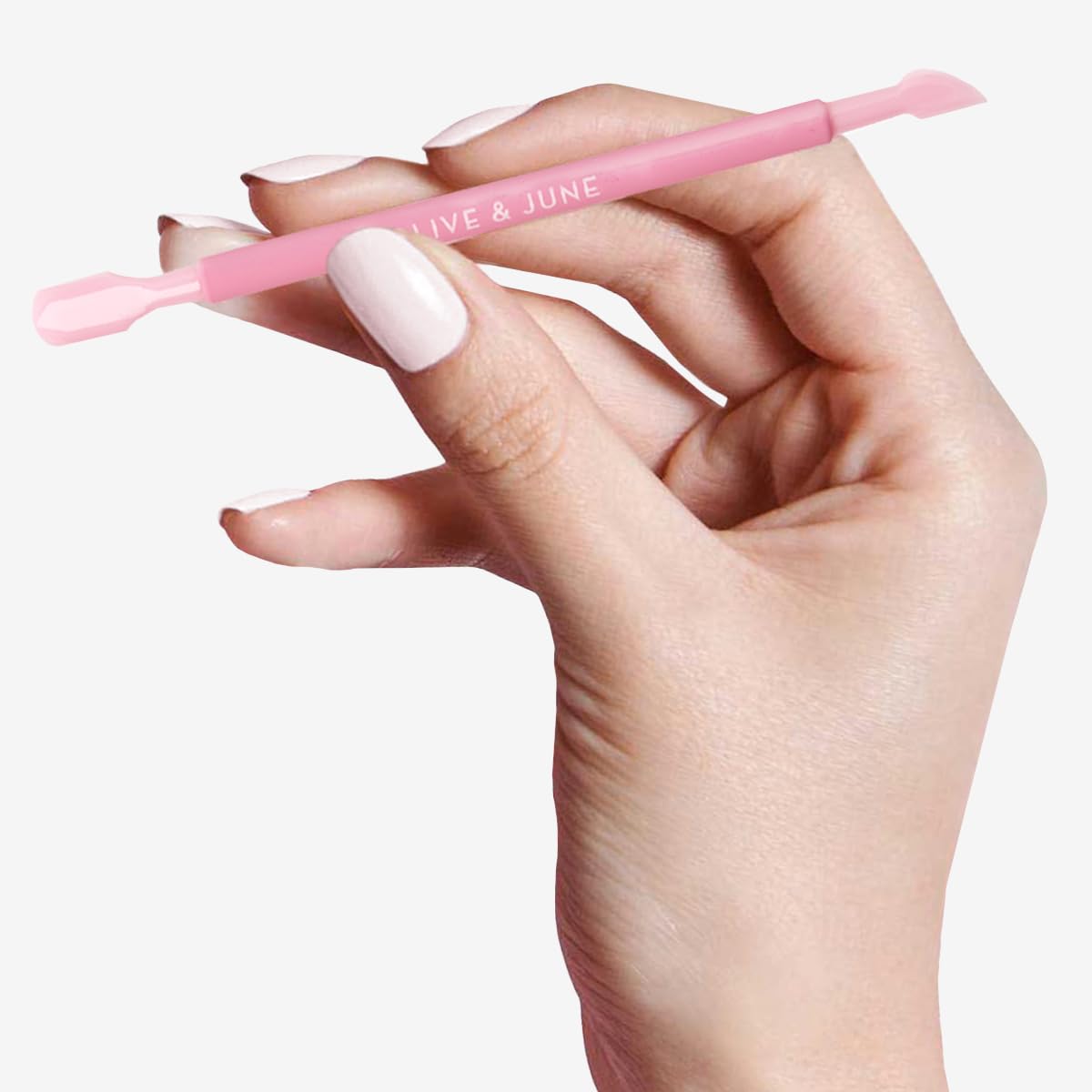 Olive And June Manicure Cuticle Pusher being held to demonstrate the stable non slip grip