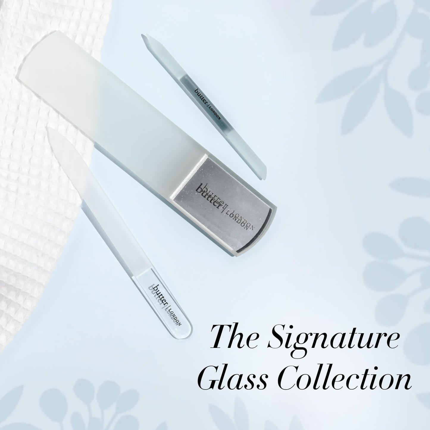 Hand using glass cuticle pusher for manicure