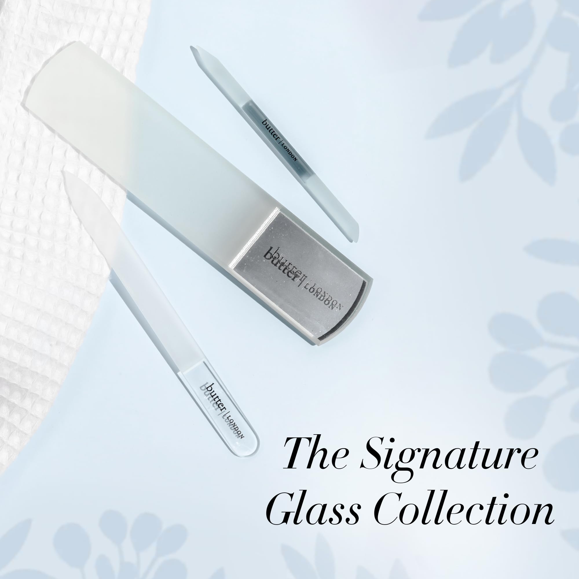 Hand using glass cuticle pusher for manicure