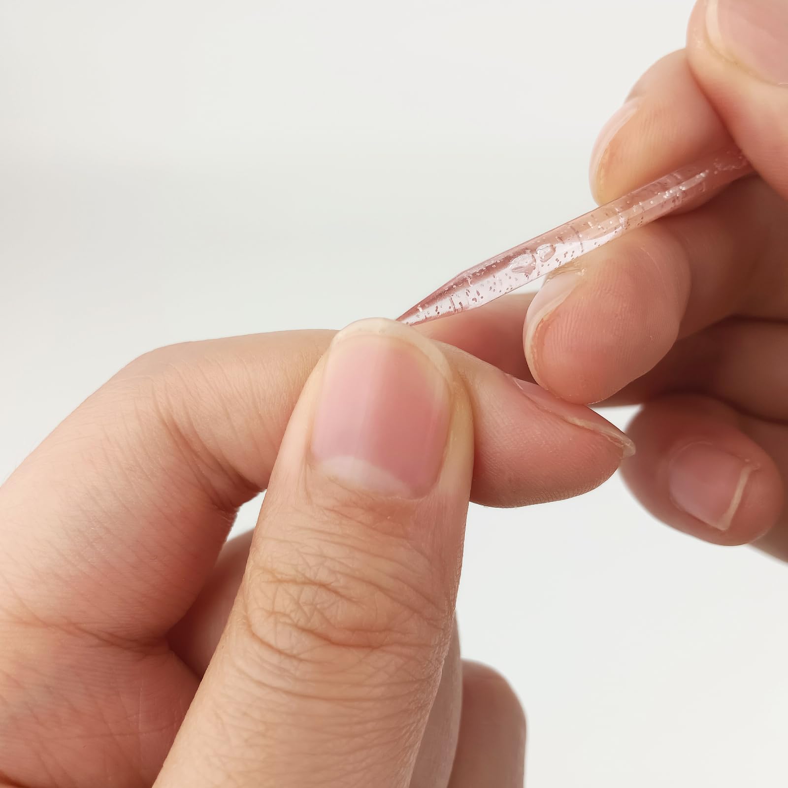 Slanted end of cuticle stick pushing back cuticles