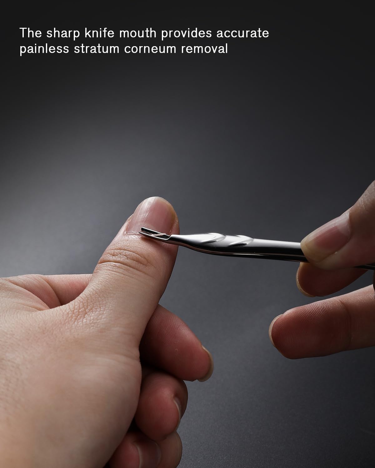 Stainless steel cuticle tool held in hand for scale