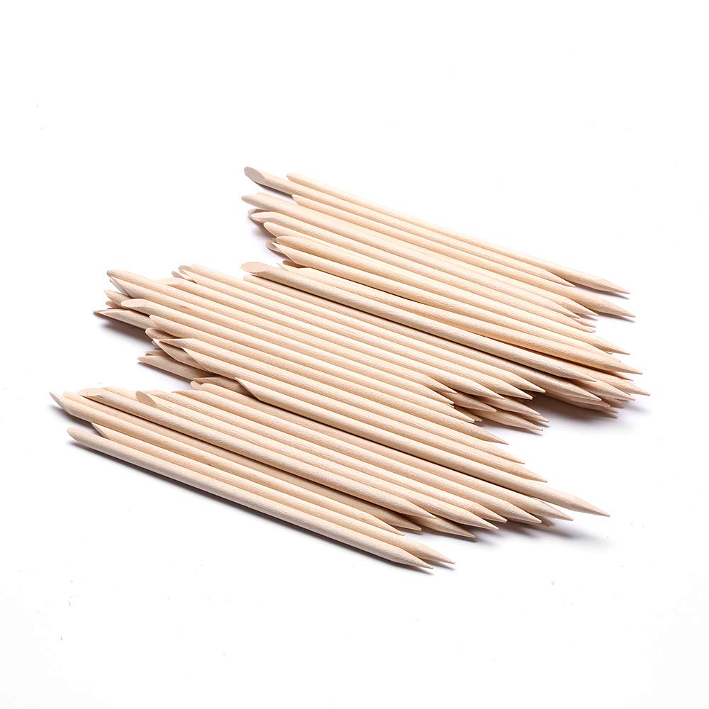 Close up of double sided orange wood cuticle pusher