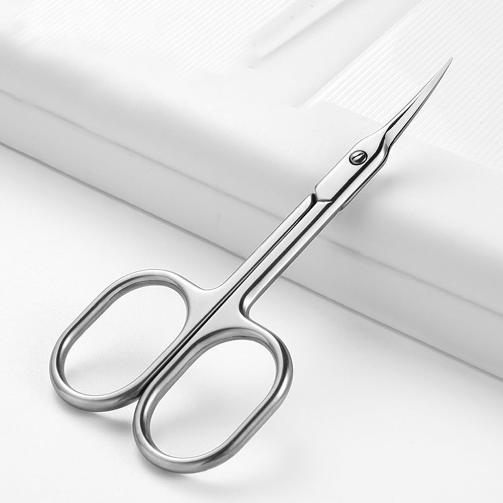 Mundial cuticle scissors cutting a precise line demonstrating product sharpness.