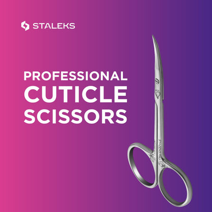 Staleks Magnolia cuticle scissors placed flat to demonstrate the straight medium handle design and ergonomics.