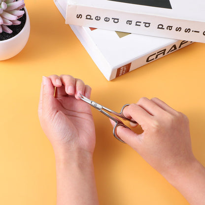 Multi purpose beauty scissors being used for precise eyebrow shaping and facial hair trimming applications.