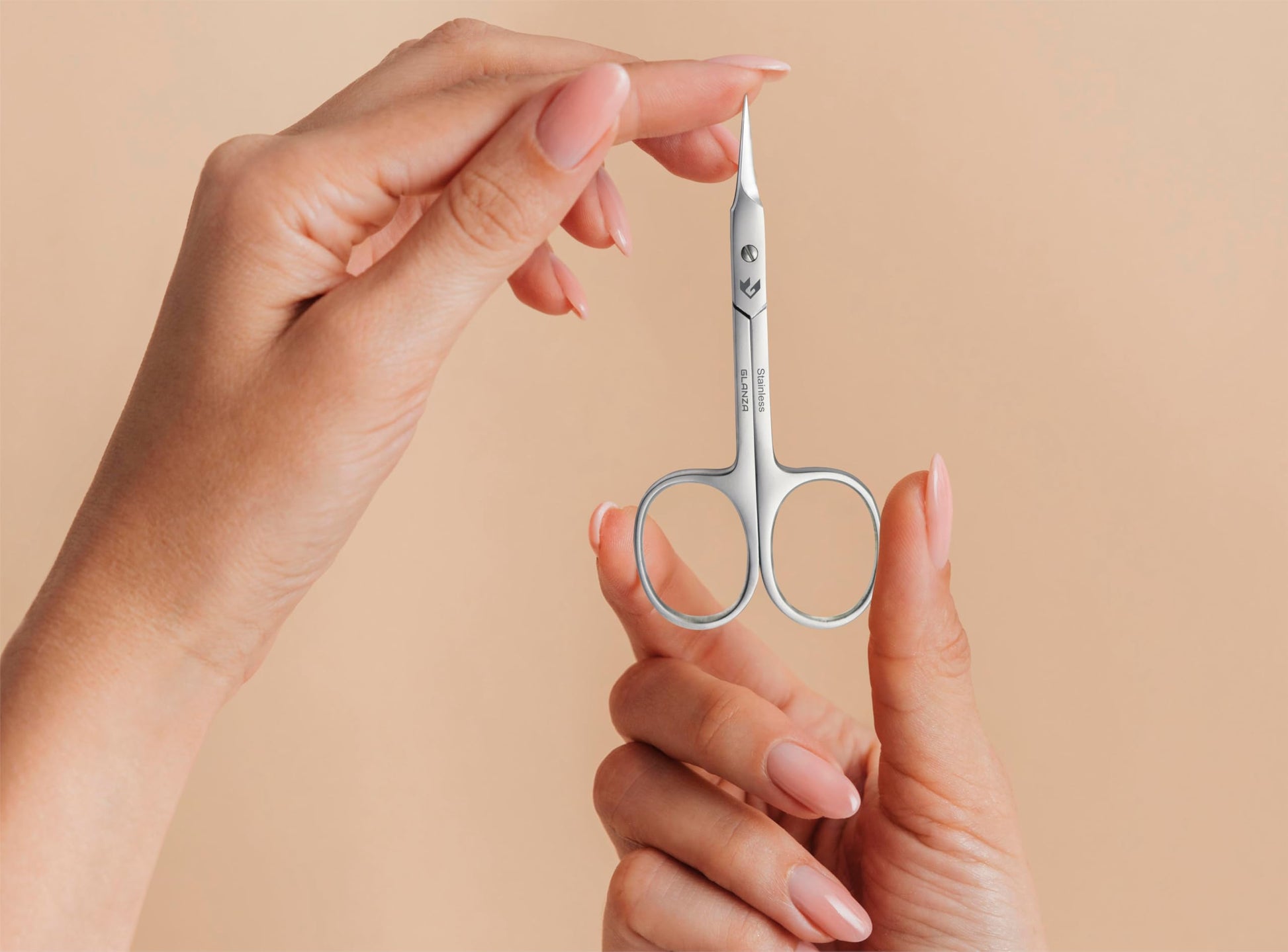 Compact travel size beauty scissors in an elegant protective pouch package.