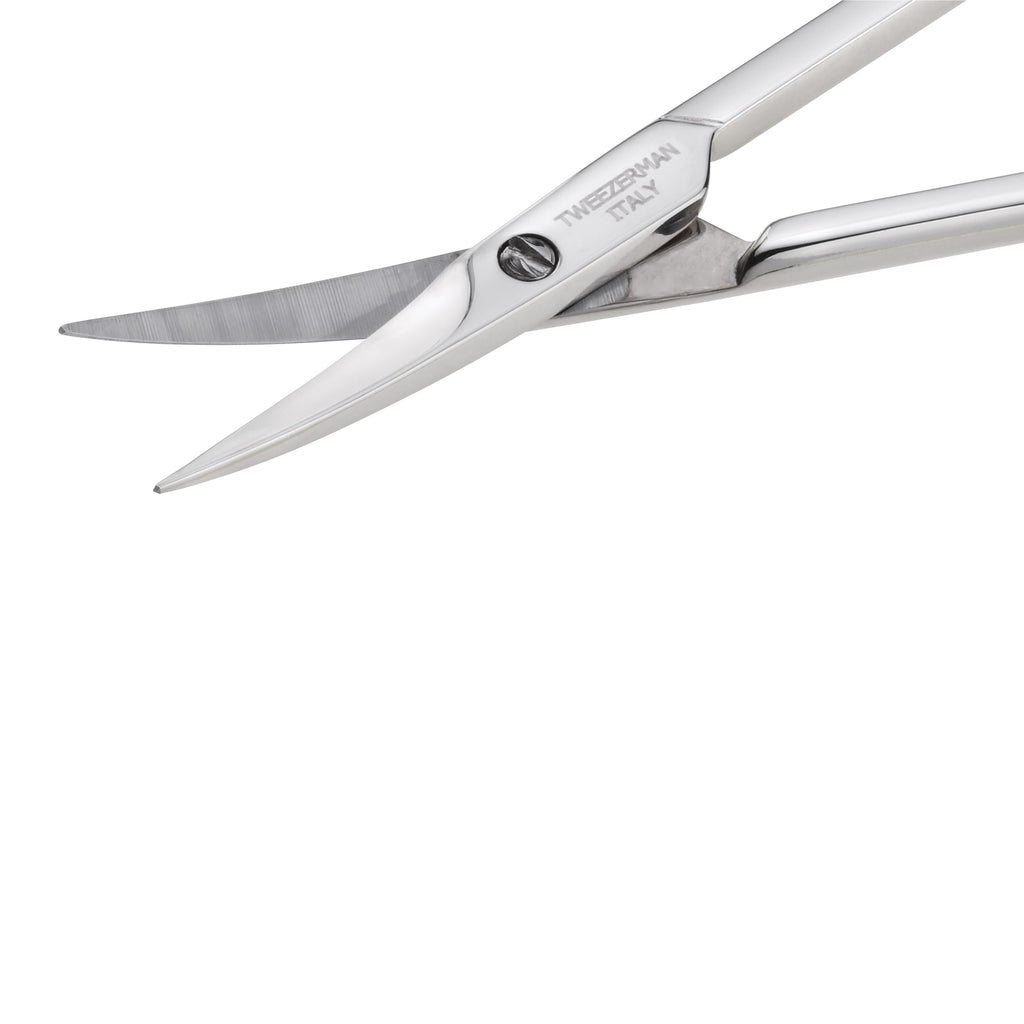 Close up angle of Tweezerman stainless steel cuticle nail scissors emphasizing the ultra fine sharp blades