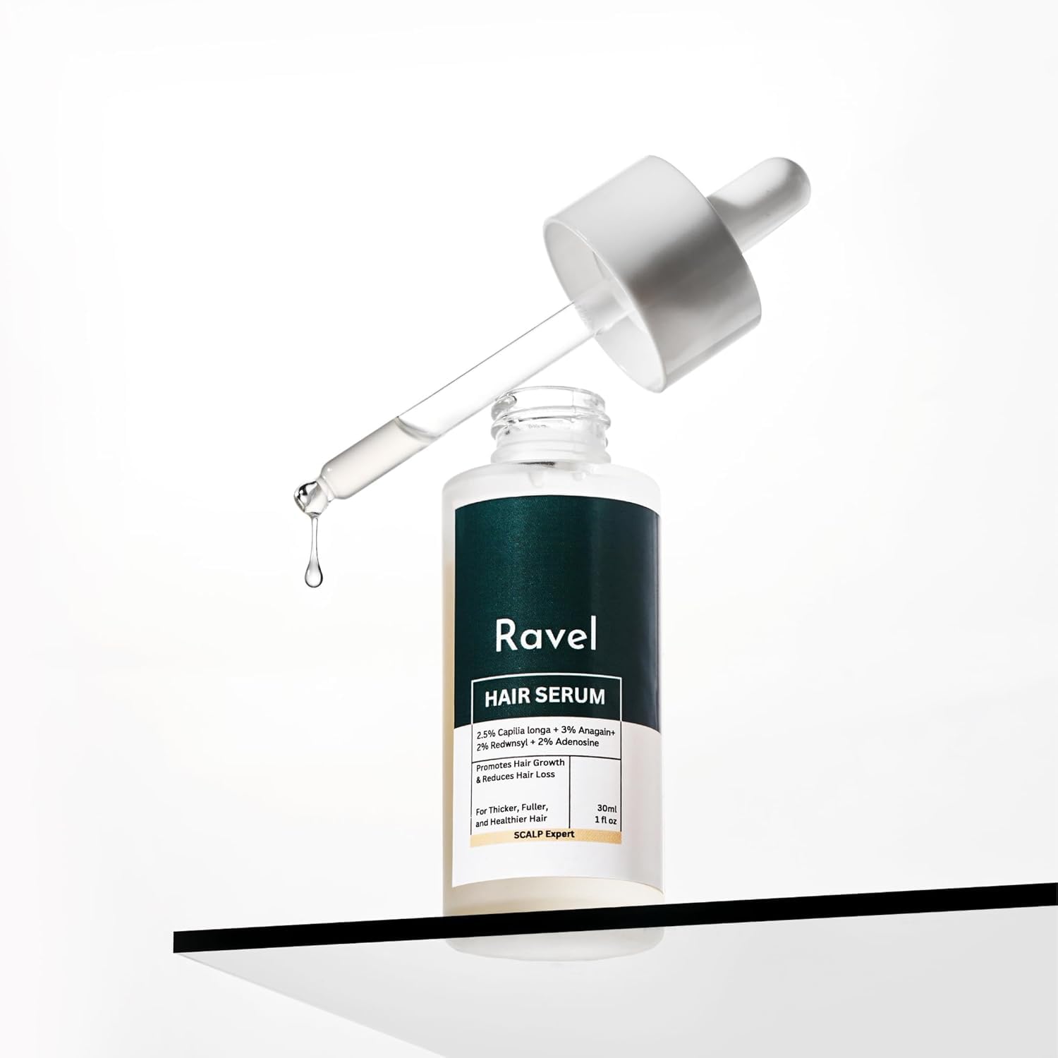 Ravel hair growth serum bottle with dropper displaying active ingredients